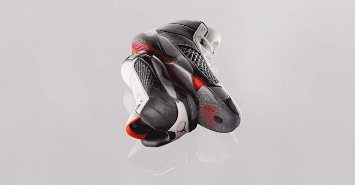 View of stacked black and red Air Jordan basketball shoes.